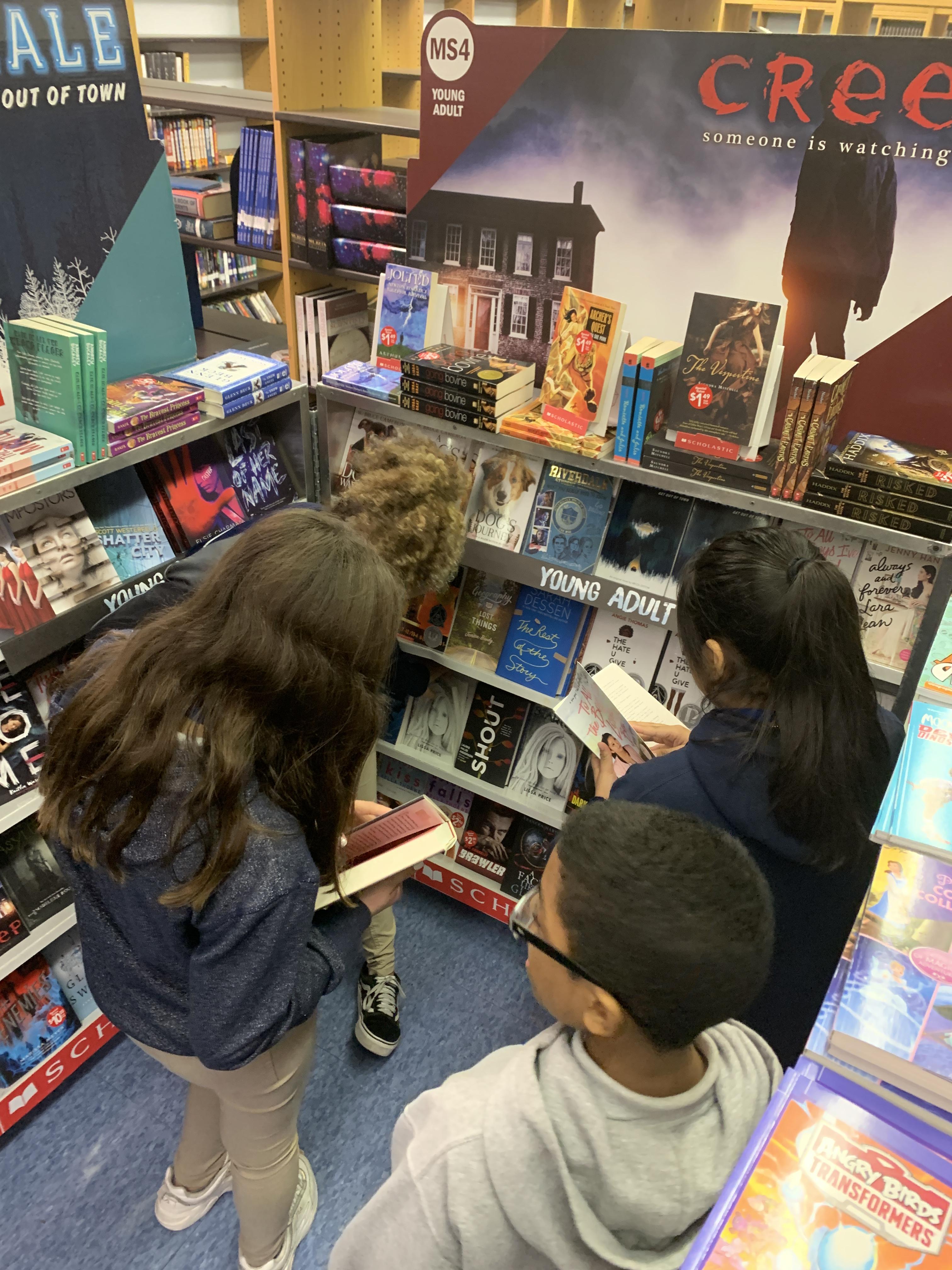 kids looking at the books in the fair