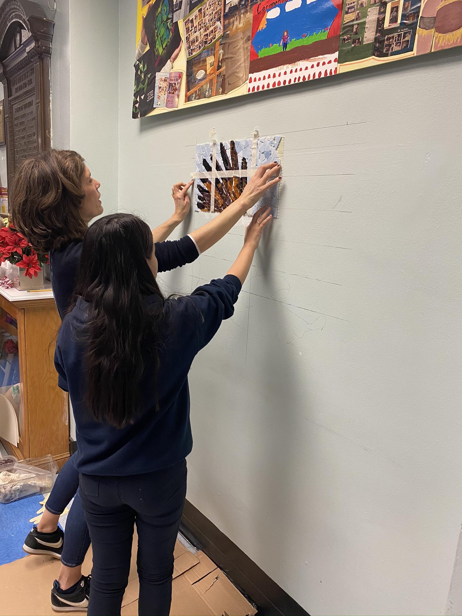 teacher and student measuring wall for mosiac
