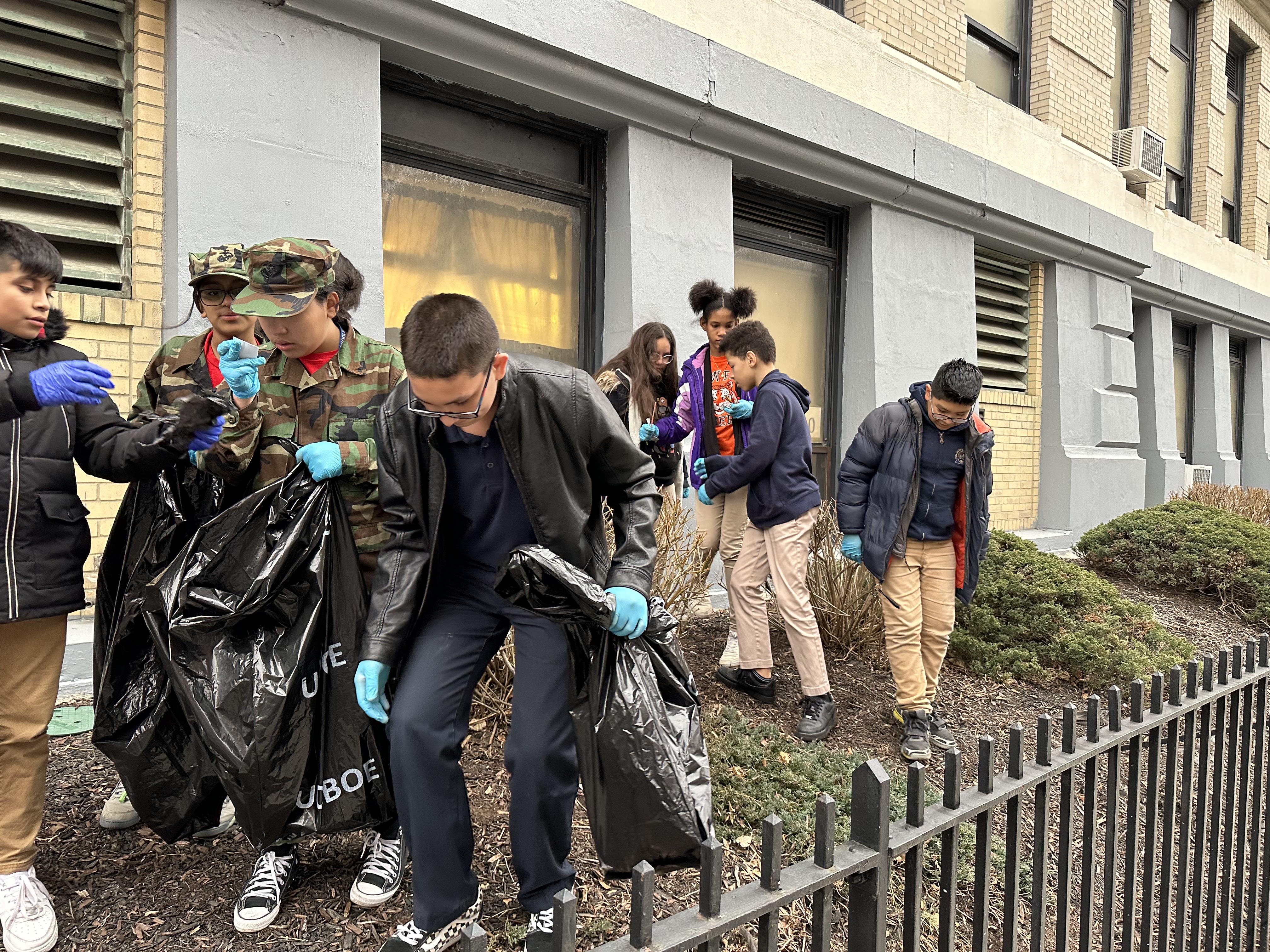 Young Marines cleaning the courtyard at the Union Hill Middle School